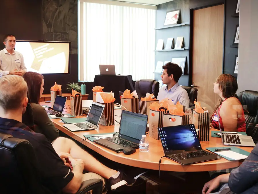 Specialists agreeing an engagement scope around a meeting table