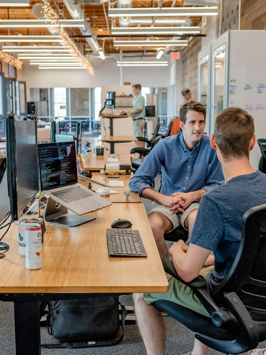 Colleagues collaborating around a shared workspace