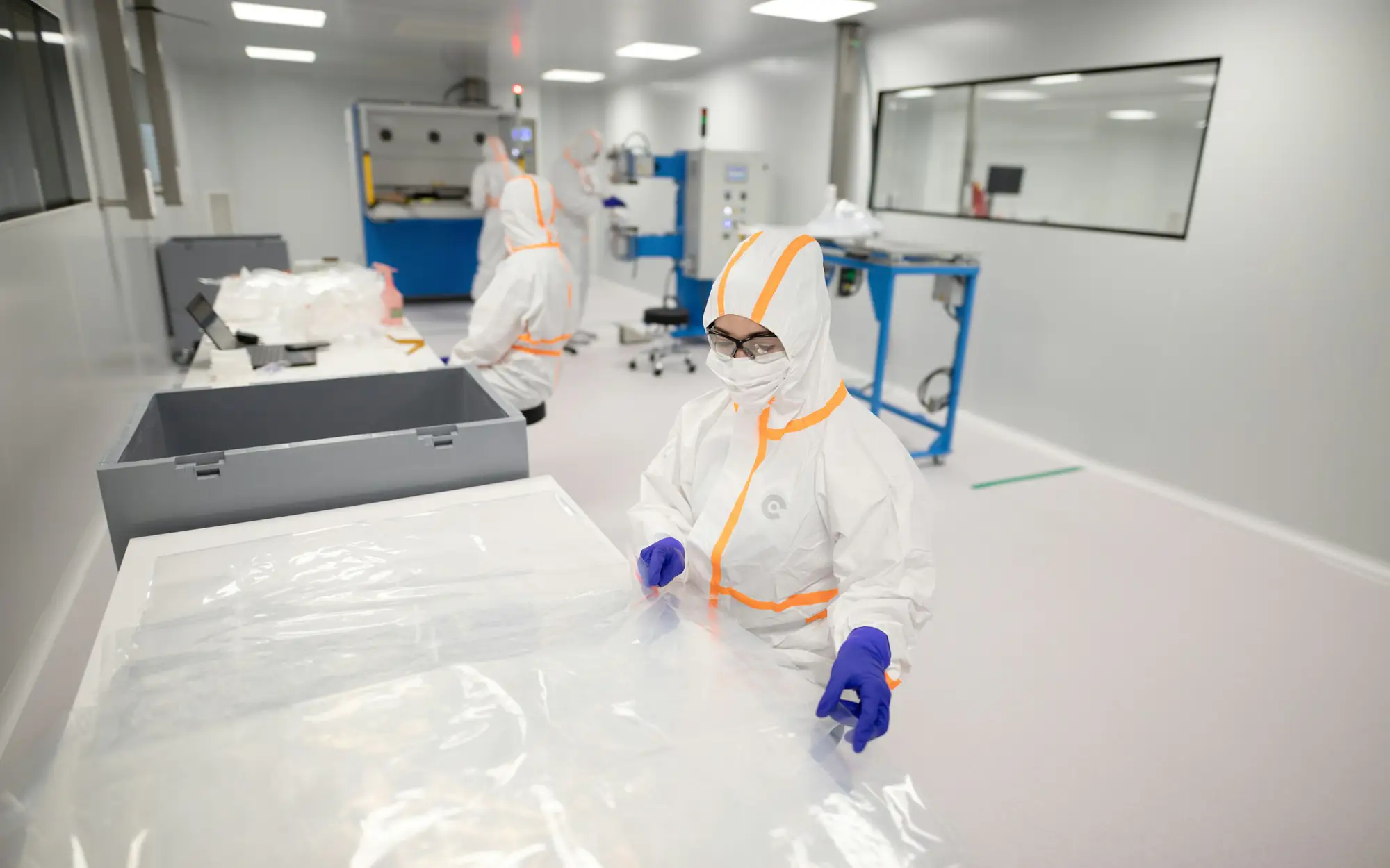 Gowned operators working in a classified cleanroom