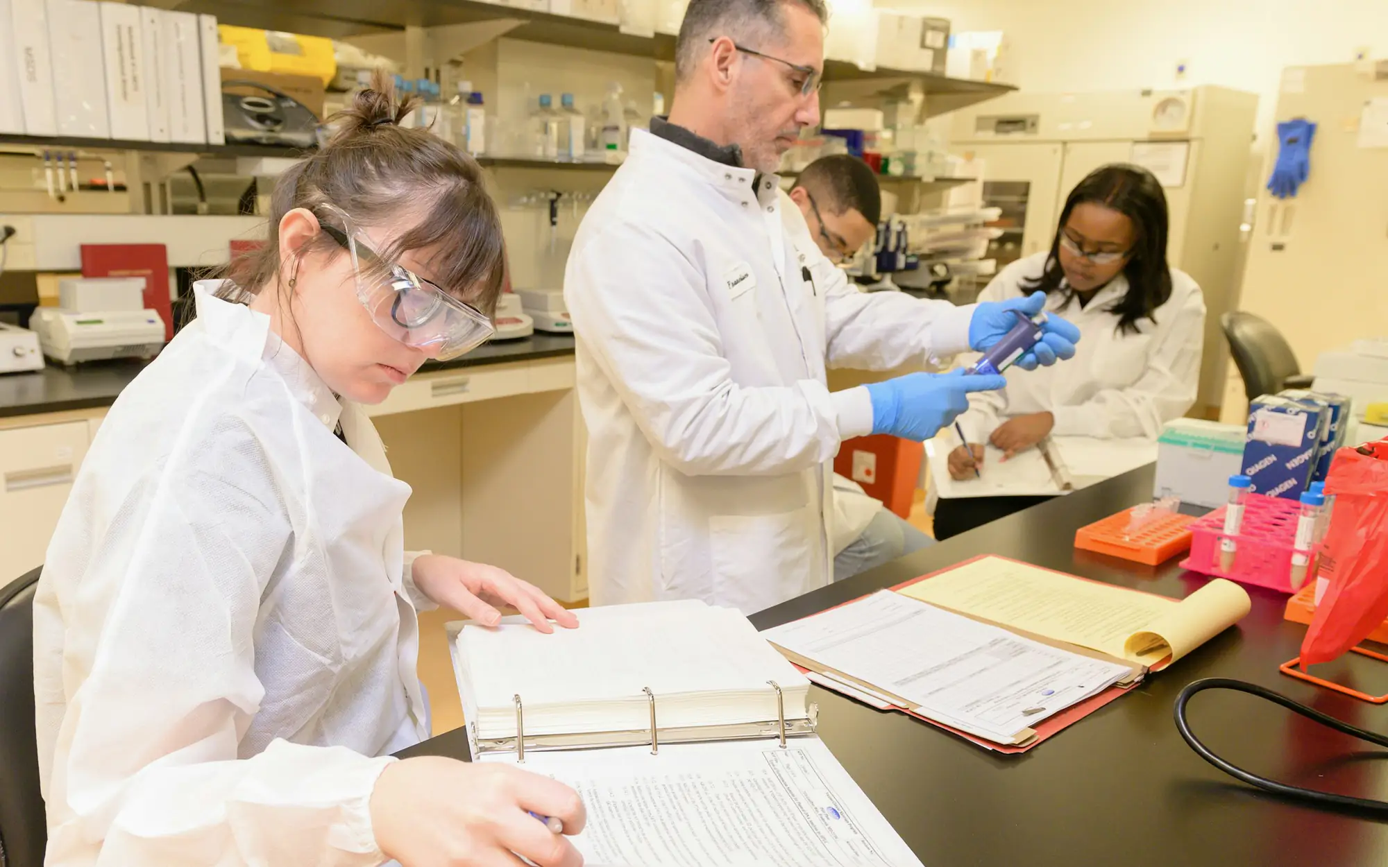 Analysts reviewing laboratory records at the bench