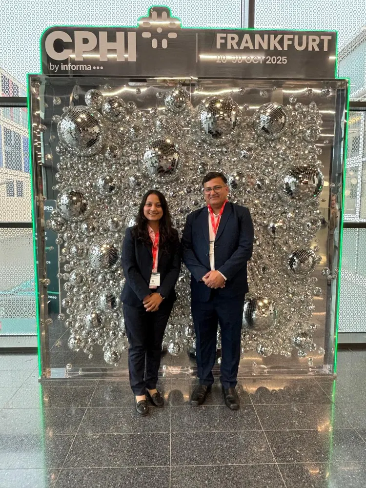 Two PharmExpert colleagues in front of the CPHI Frankfurt 2025 backdrop