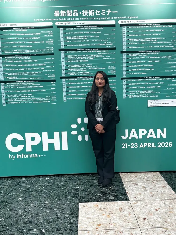 A PharmExpert colleague beside the CPHI Japan signage at the venue entrance