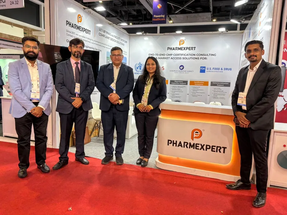 PharmExpert team standing at the branded PharmExpert exhibition booth on a trade-show floor