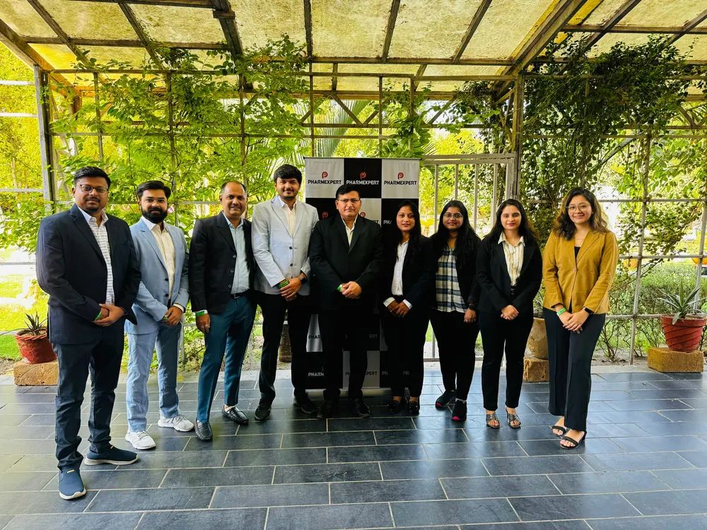 PharmExpert team group photo on the covered terrace outside the Ahmedabad office